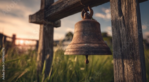 Close-up of rustic bell hanging from wooden crossbeam in golden hour light