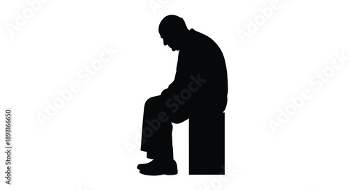A somber man sits with his head in hands a dark silhouette