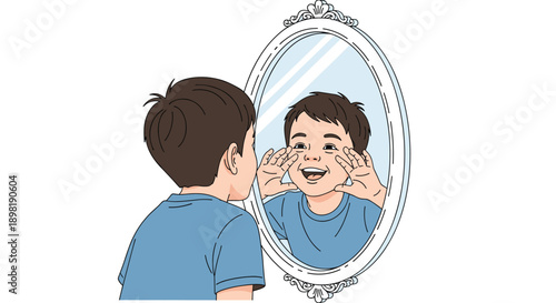Happy young boy looking at himself in a decorated vintage oval mirror while making funny faces and smiling with joy.