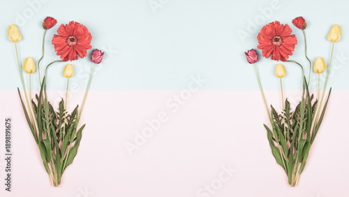A frame of bouquets of yellow and red tulips and red poppies on a light pink and blue background, top view of a flat surface with a copy space