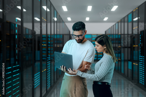 3D coworkers reviewing server data on laptop screen