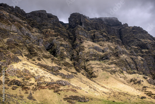 A breathtaking landscape of jagged cliffs and eroded rocks, captured in natural light with cloudy skies. The wild, isolated terrain makes this image suitable for adventure, exploration, and nature.