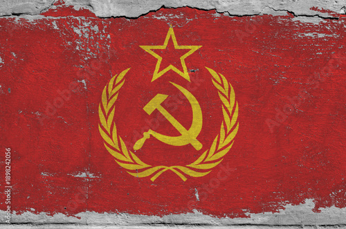 flag of the Soviet Union are painted on an old stone wall