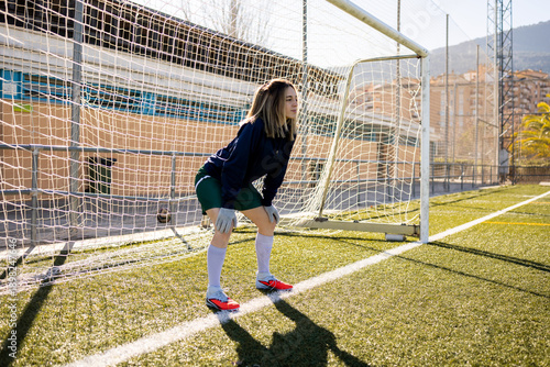Fotografija Photograph of a female soccer goalkeeper waiting to receive a free kick or penalty on a soccer field