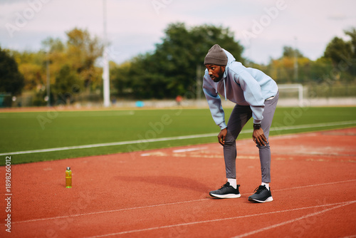 Bild auf Leinwand Focused athlete recovering after running session