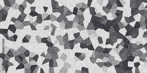 Abstract grayscale mosaic pattern with granular texture and irregular polygonal shapes creating a dynamic and textured background for design projects