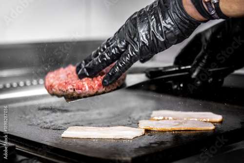 Photos Chef cooking angus beef burger and bacon on grill