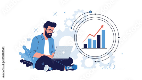 Focused man using a laptop while sitting on the floor surrounded by giant gears and business growth charts.