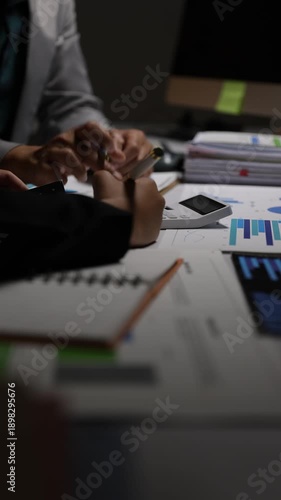 Business people brainstorming and discussing data analysis charts. Professionals working on a project, reviewing graphs and statistics.