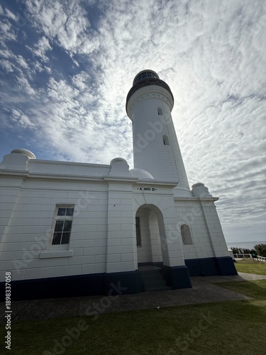 Historic White Lighthouse Against Dramatic Sky