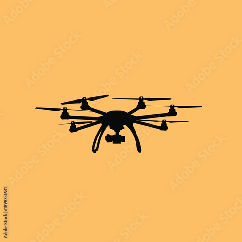 A sleek quadcopter drone in mid-flight against a warm background