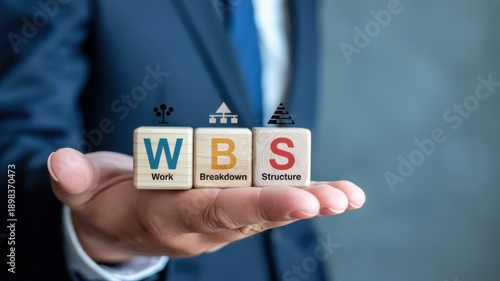 Businessman holding wooden blocks with WBS Work Breakdown Structure acronym for project management
