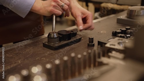 Jewelers hand using professional ring bender.