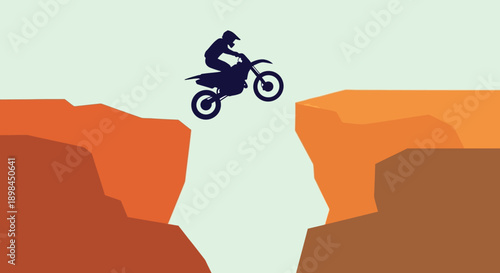 Motorcycle rider jumping over a canyon gap.