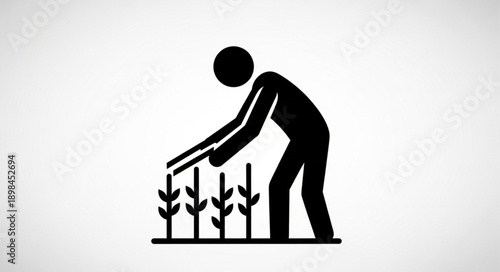 Farmer tending to crops icon silhouette.
