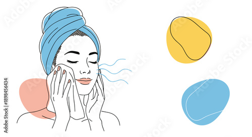 Beautiful young woman with a blue towel on her head drying her face after a shower for a clean skin and beauty care routine.
