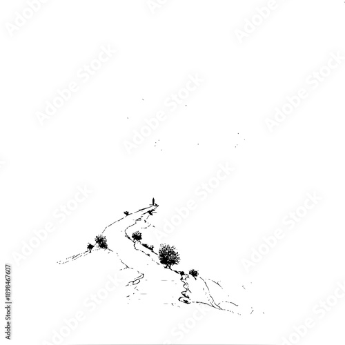A winding path leads to a solitary figure standing at the summit with trees on a hill in black and white