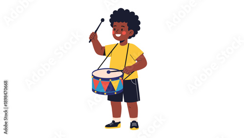 Happy young boy with curly hair wearing a yellow shirt and playing a colorful drum with drumsticks in a joyful musical performance.