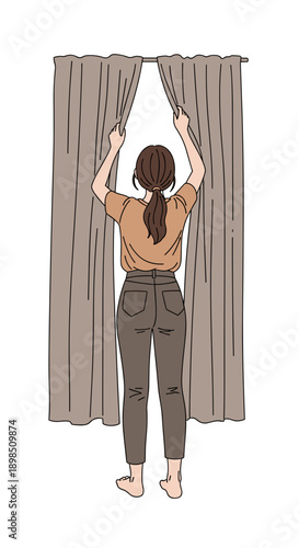Woman opening curtains in living room to let in light  