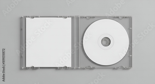 blank dvd case, Open clear plastic CD jewel case with blank white disc and insert for branding. Mock-up of compact disc packaging on soft gray background. Represents digital storage, music or software