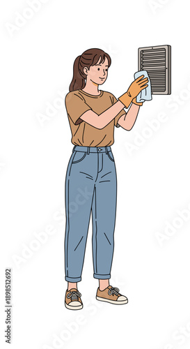 Woman cleaning air vent while standing indoors in casual attire  