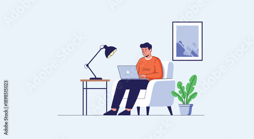 Man working remotely on his laptop while sitting comfortably in a white armchair next to a desk lamp and a leafy green plant.