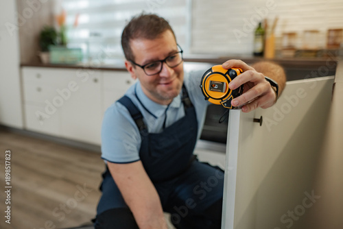 Wallpaper Mural Handyman measuring kitchen cabinet for home renovation Torontodigital.ca