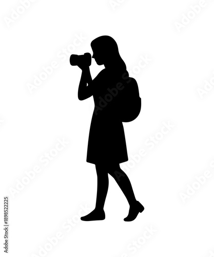 Tourist female photographer silhouette holding camera and backpack