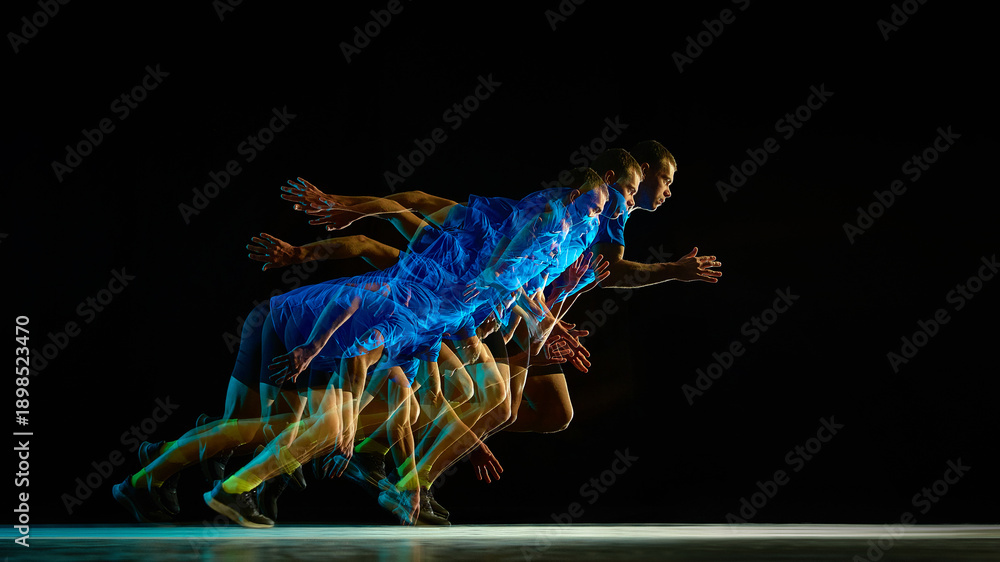 Fototapeta premium Stroboscopic sprint start with overlapping runner motion on black background. Concept of explosive launch, forward drive, reaction speed, kinetic energy transfer, high performance athletic movement.