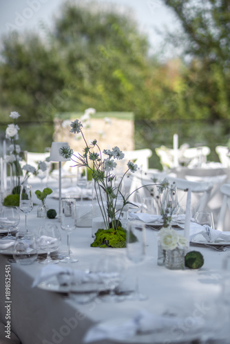 Quadro su tela Long outdoor wedding table styled in white with minimalist floral centerpieces and glassware