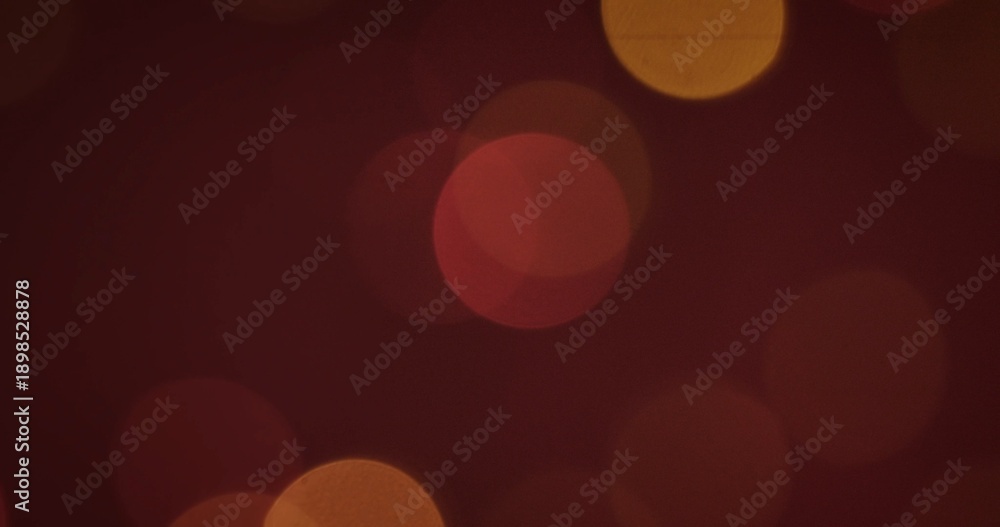 Fototapeta premium An abstract background featuring soft bokeh lights in warm red and yellow colors, creating a dreamy atmosphere.