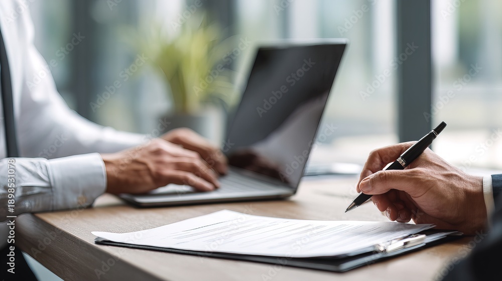 Fototapeta premium Professional hr manager engaged in typing notes on laptop in modern office setting with natural light focus on productivity and efficiency