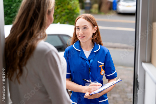 Nurse visits a patient at home to check on health and provide care instructions in the afternoon