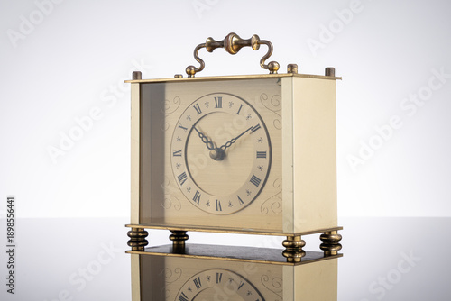 Wallpaper Mural Elegant vintage carriage clock with a brass frame and roman numerals. A timeless antique object symbolizing history, tradition, and the passage of time. Torontodigital.ca