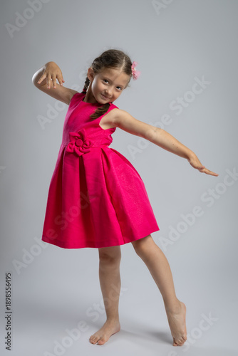 Wallpaper Mural Smiling Young Girl in Elegant Pink Dress Posing in Studio. Happy Childhood Fashion Portrait, Kids Clothing, Celebration, Birthday and Family Lifestyle Concept Torontodigital.ca