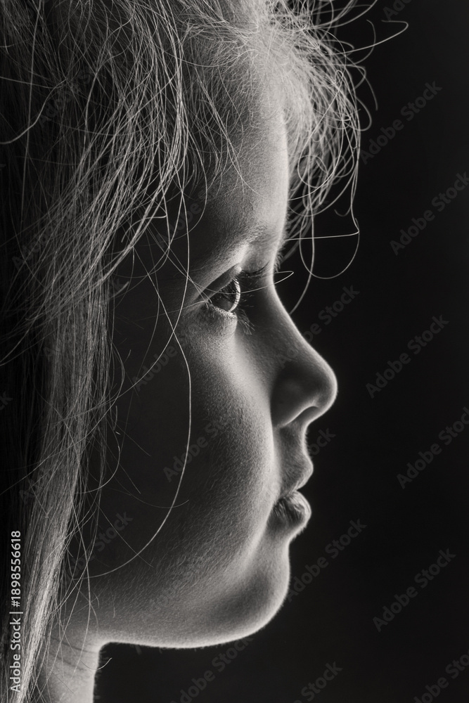 custom made wallpaper toronto digitalBeautiful black and white profile portrait of a little girl's face, isolated on a dark background. A touching and dramatic image of childhood innocence, contemplation, and dreams.
