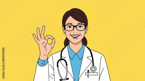 Friendly female doctor in white coat and stethoscope smiling while giving okay hand gesture on yellow background.