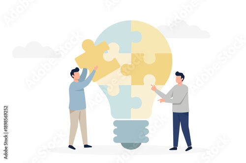 Two businessmen assembling light bulb puzzle pieces for creative idea concept