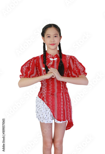 Cute young Asian girl in red Chinese-style dress, performing a traditional 