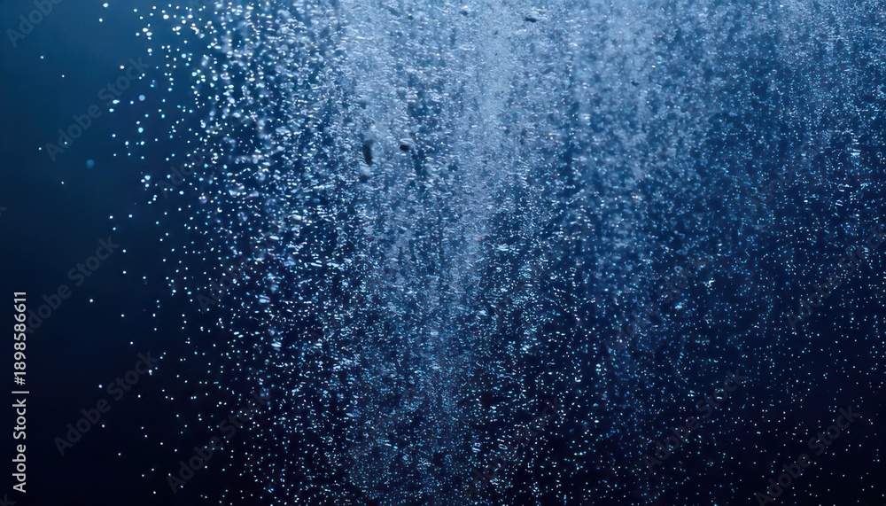 Obraz premium Bubbles rising in deep blue water creating a mesmerizing effect.