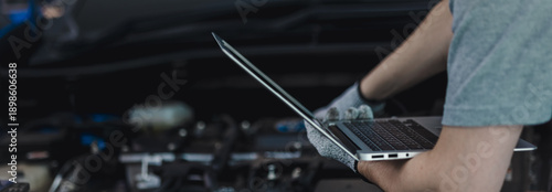 Canvastavla Close-up of a car diagnostic system in use, as a skilled mechanic carefully insp