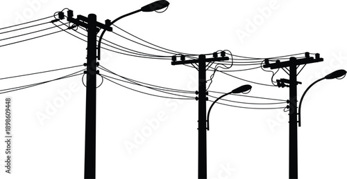 Silhouette of three utility poles with streetlights and tangled wires Keywords: utility pole, streetlight, power line