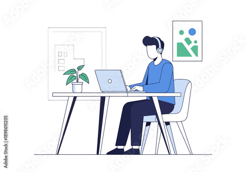 Man wearing headphones works diligently on a laptop computer at a desk in a modern minimalist home office space with a plant and artwork on the wall