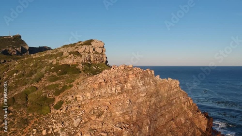 Panoramic view of the rugged cliffs and turquoise ocean at the Cape of Good Hope, South Africa