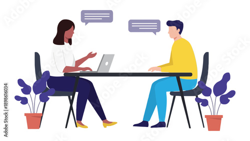 Two colleagues collaborating on a project at a table with laptops