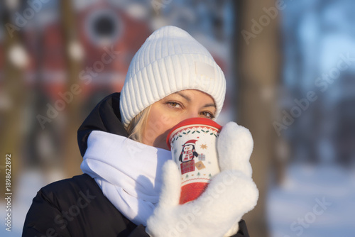 Young beautiful girl walking in a winter park.