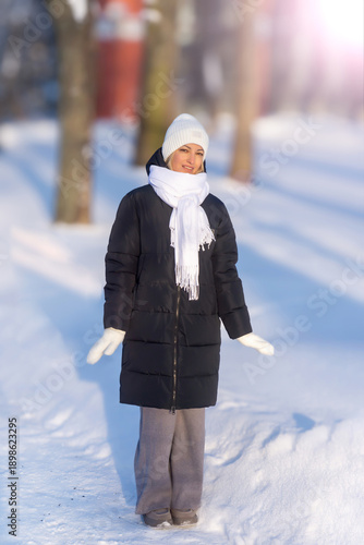 Young beautiful girl walking in a winter park.