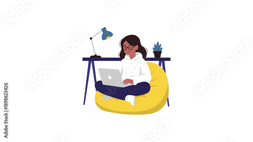 A woman sits comfortably on a yellow bean bag with her laptop