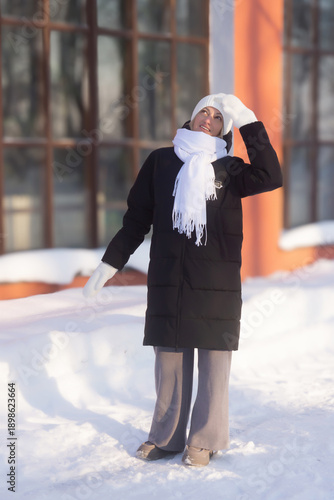 Young beautiful girl walking in a winter park.