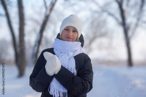 Young beautiful girl walking in a winter park.
